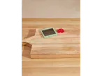 Vegetable chopper and diced red pepper on a wooden cutting board.