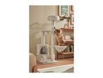 A fluffy brown cat playing on a multi-level cat tree with scratching posts and a hanging toy.
