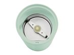 Top-down view of a light green electric coffee grinder with a metal blade.