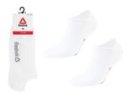 Two pairs of white no-show socks, one pair on a hanger, the other two loose.