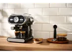 SilverCrest espresso machine on a wooden counter with two coffee cups and cookies.