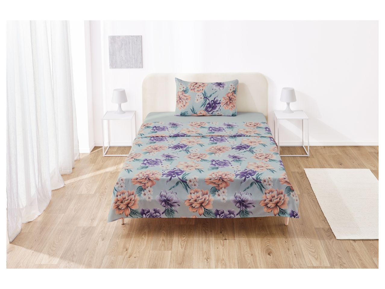 A twin-size floral bedsheet set with matching pillowcase in a light teal color scheme.