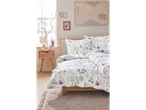 Floral bedding on a light wood bed frame.