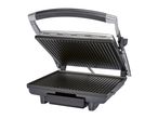 A black and silver contact grill is open, displaying its ridged grilling plates.