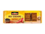 Fajita flavour rice crackers in a yellow package with red chili peppers and black peppercorns.