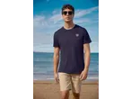 Man in Esmara shorts and a navy t-shirt with a compass logo on a beach.