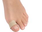 A foot with a beige toe bandage on the big toe, isolated on a white background.