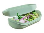 Green silicone steamer with lid, filled with Romanesco broccoli, asparagus, and red onion.