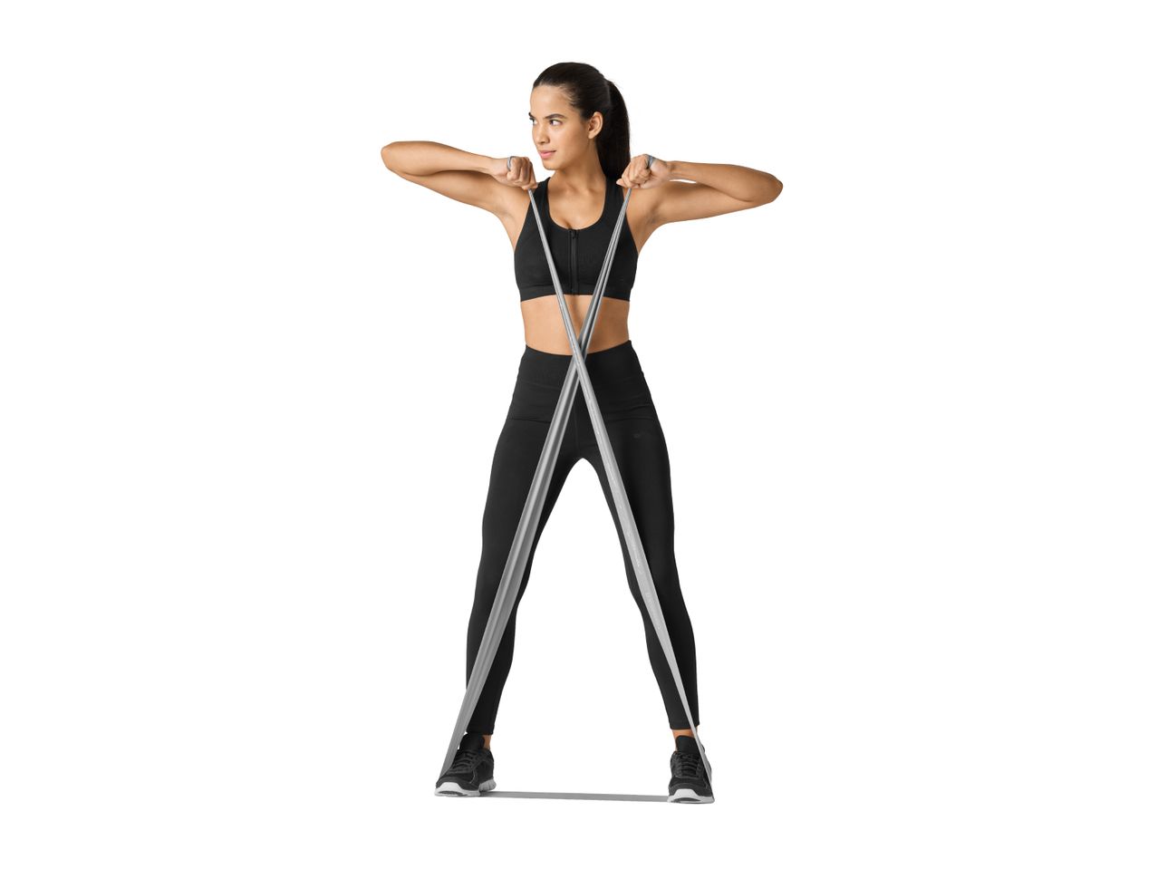 Woman in black sportswear exercising with a resistance band.