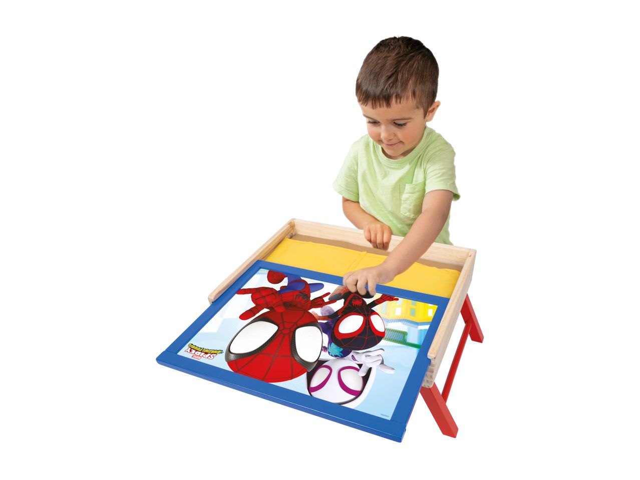 A young boy playing with a Spider-Man themed wooden activity table.