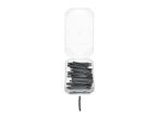 A clear plastic box filled with black heat shrink tubing, with one piece lying separately.