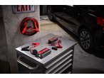 ULTIMATE SPEED® Portable Jump Starter with Power Bank and battery charger on a metal workbench in a garage.
