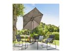 Outdoor patio set with a black metal table, four chairs, and a large grey umbrella.