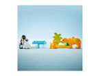 Toy penguins and lions with building blocks on a light blue background.