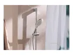 Chrome shower head and rail in a modern bathroom with a white shower curtain.