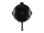 A black SilverCrest cast iron pan with a textured surface and a long handle.