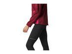 Person in a maroon long-sleeved top and black leggings with reflective details.