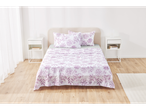 Purple floral patterned bedding in a white bedroom