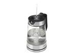 Water being poured into a glass electric kettle with a black handle and silver base