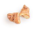Two sesame croissants with sausages.