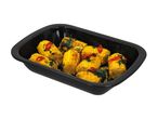 Roasted corn on the cob with herbs, chili, and lime in a black baking dish.