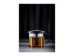 Glass teapot with a black lid and handle, filled with amber tea and an infuser.