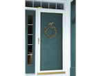 Green door with a wreath hanging from a 3M Command hook