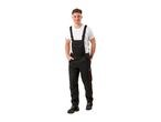 Man in black work overalls with red accents and a white t-shirt, smiling.