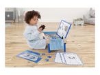 Child playing with a blue magnetic board, puzzle, and coloring pages on a wooden floor.