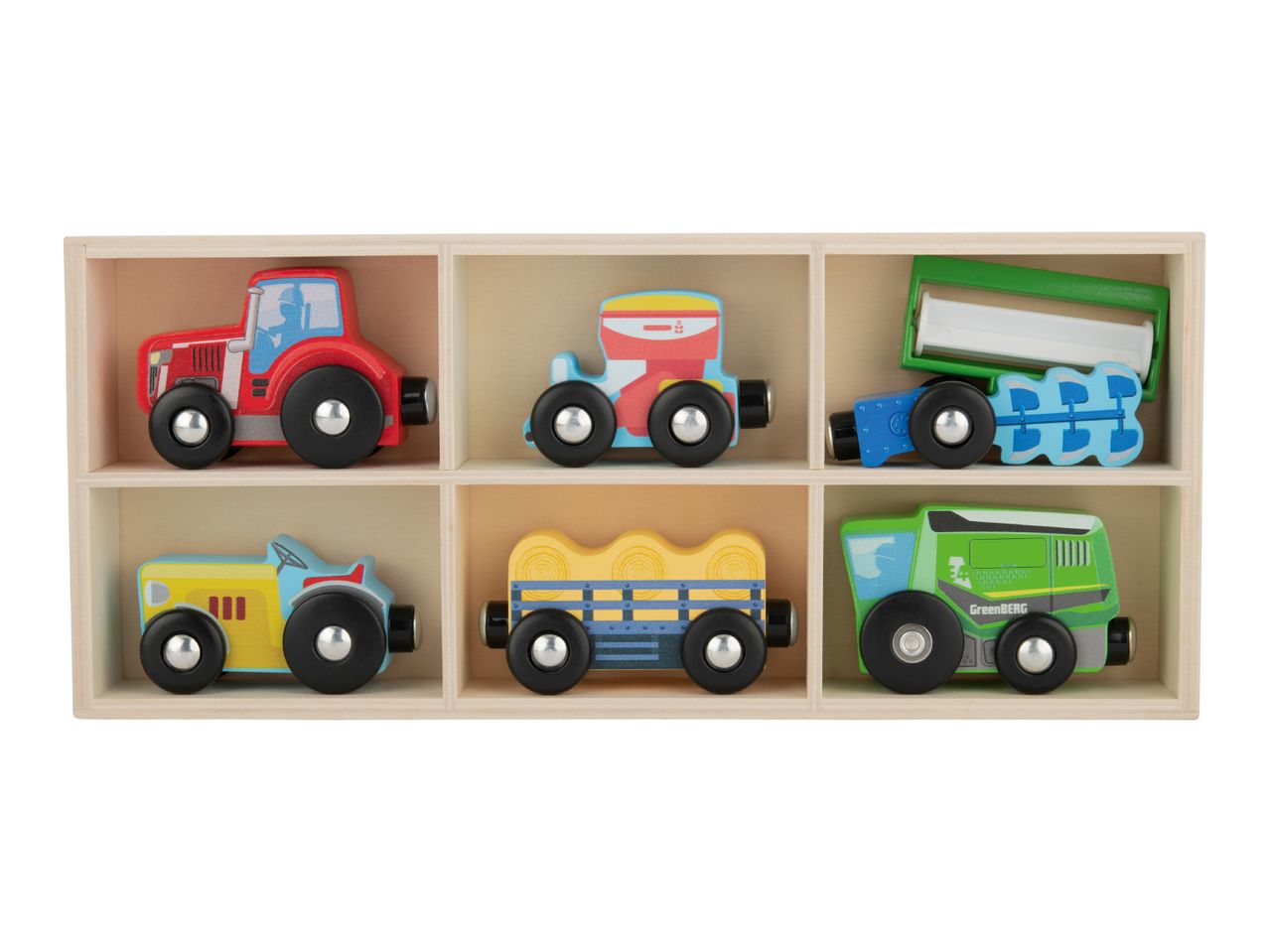 Wooden toy farm vehicles, including tractors, a seeder, a hay wagon, and a tipper, in a wooden box.