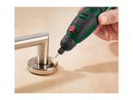 A person using a rotary tool with a polishing attachment on a metal door handle.