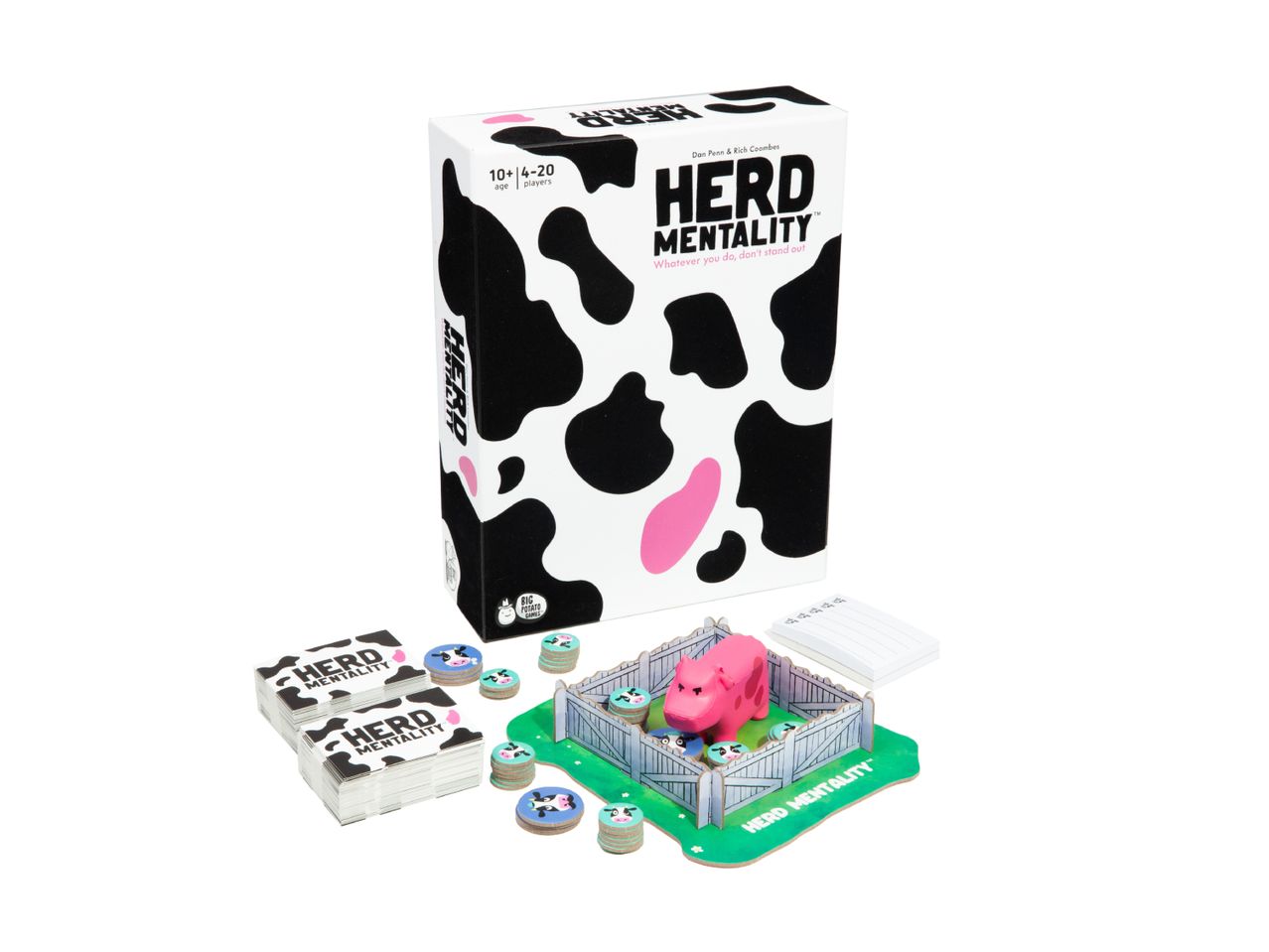 A board game called 'Herd Mentality' with cow-print packaging, cards, tokens, a pink pig, and a pen.