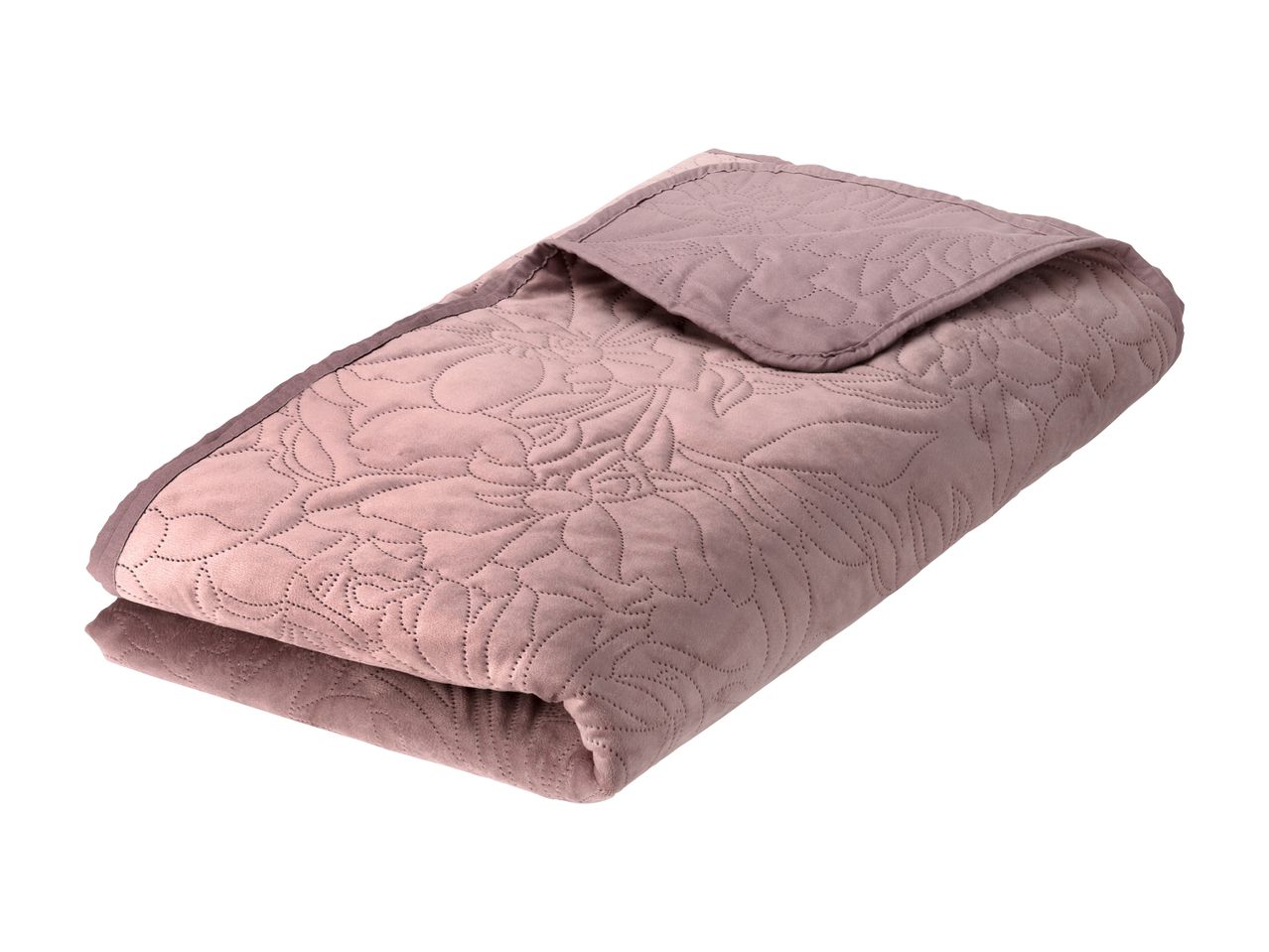 Folded pink quilted blanket with a floral pattern
