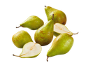 Fresh green pears, some whole and some halved, with water droplets on a black background.