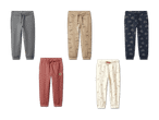 Fünf verschiedene Jogginghosen für Kinder, darunter einfarbige, gemusterte und bedruckte Designs.