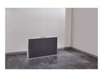 Foldable table in a room with white walls and dark tiled floor