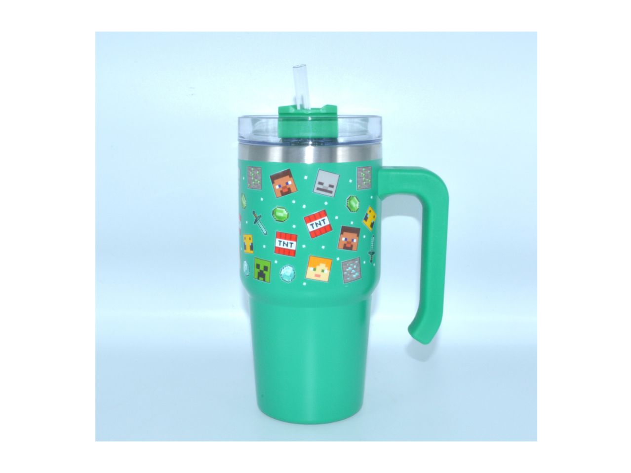 A teal travel mug with a handle and festive design.