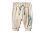 Tom and Jerry beige sweatpants with white side stripes and a teal drawstring.