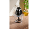 SILVERCREST® Mini Chopper on a wooden surface with olive oil and herbs in the background.