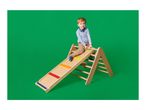 A young boy on a wooden climbing frame with a slide, featuring colorful steps.