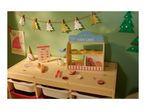 Kids' wooden play cafe with toy food, a menu, and Christmas decorations.