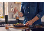 SILVERCREST® Electric Salt/Pepper Mill in use, seasoning a steak with vegetables.