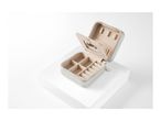 A beige, square jewelry box with compartments for earrings and other small accessories is open.
