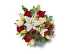 Christmas bouquet with white lilies, red and cream roses, pine cones, and red berries.