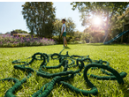 Parkside® 15m Flexible Garden Hose Set on grass with a child in the background.