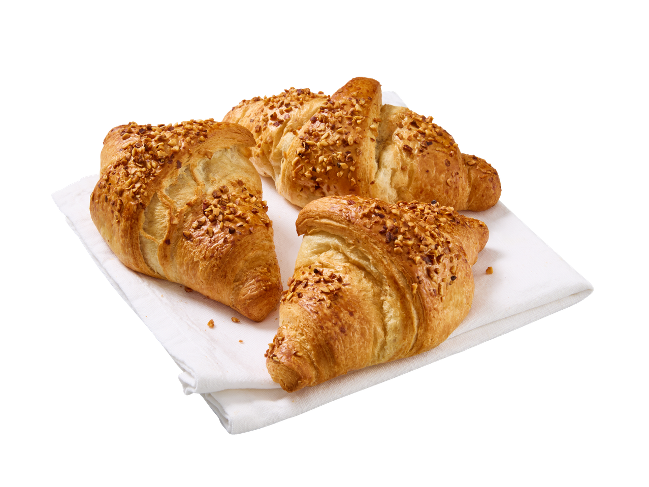 Kolm mandlikroissantti valgel salvrätikul.