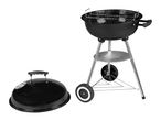 Black kettle barbecue grill with a lid, on wheels, for outdoor cooking.