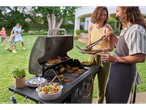 Family enjoying a barbecue with burgers and vegetables on a Grillmeister grill.