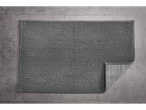 LIVARNO home gray bath mat with a corner folded back on a tiled floor.