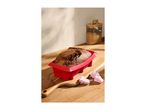 Marble cake in a red silicone loaf pan on a wooden board with pink marshmallows.